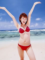 Big breasted asian idol soaks up the rays in her bikini at beach